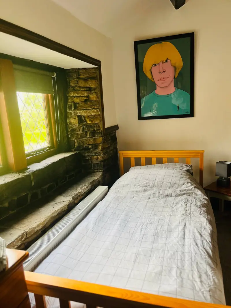 Twin bedroom with exposed stonework