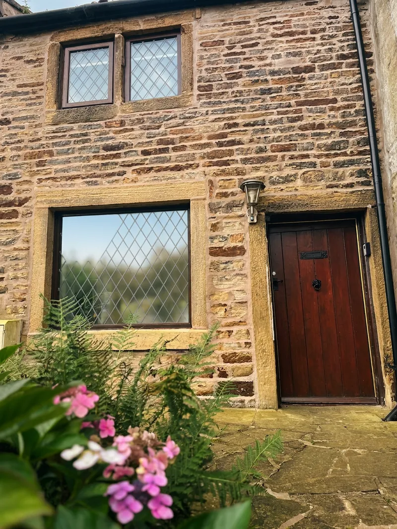 The oak front door of Spring Cottage, where the walks begin