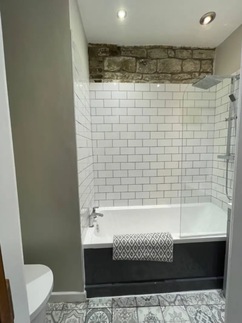 Bathroom with deep bath and rain shower
