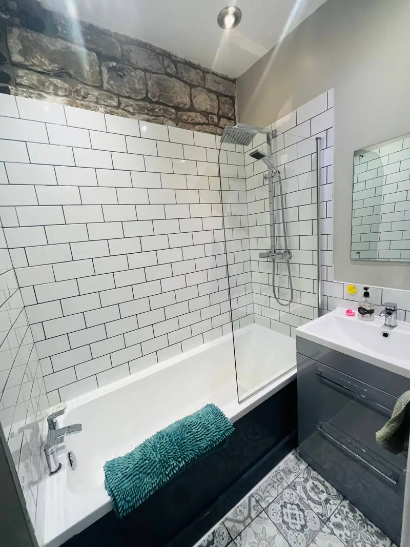 Bathroom with metro tiles and 300-year-old stonework