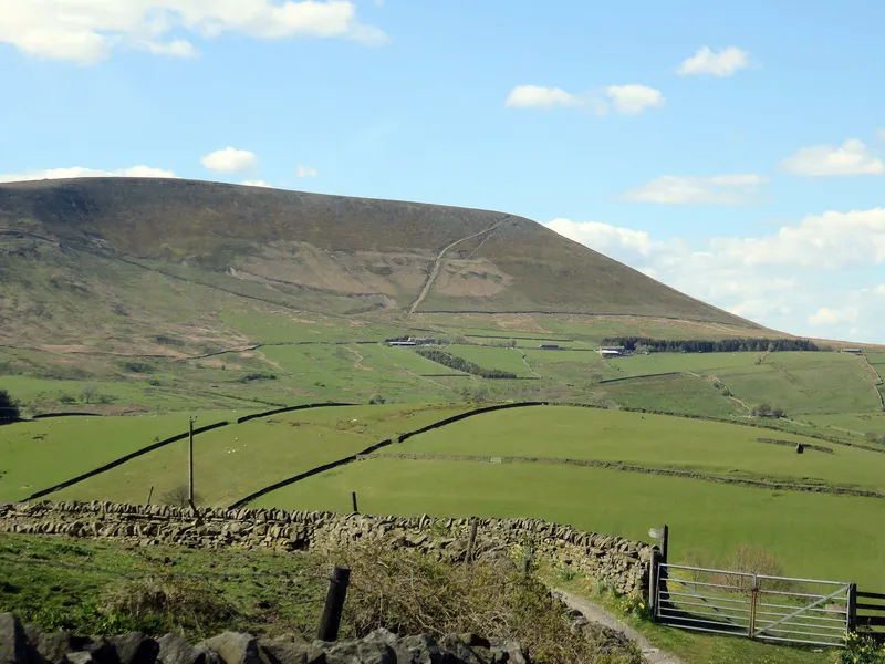 Pendle Hill rising above green fields